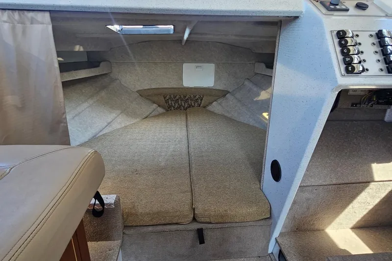 Slide: The Image of Interior cabin of 2016 KingFisher 3025 Destination boat, featuring seating and control panel. - 16