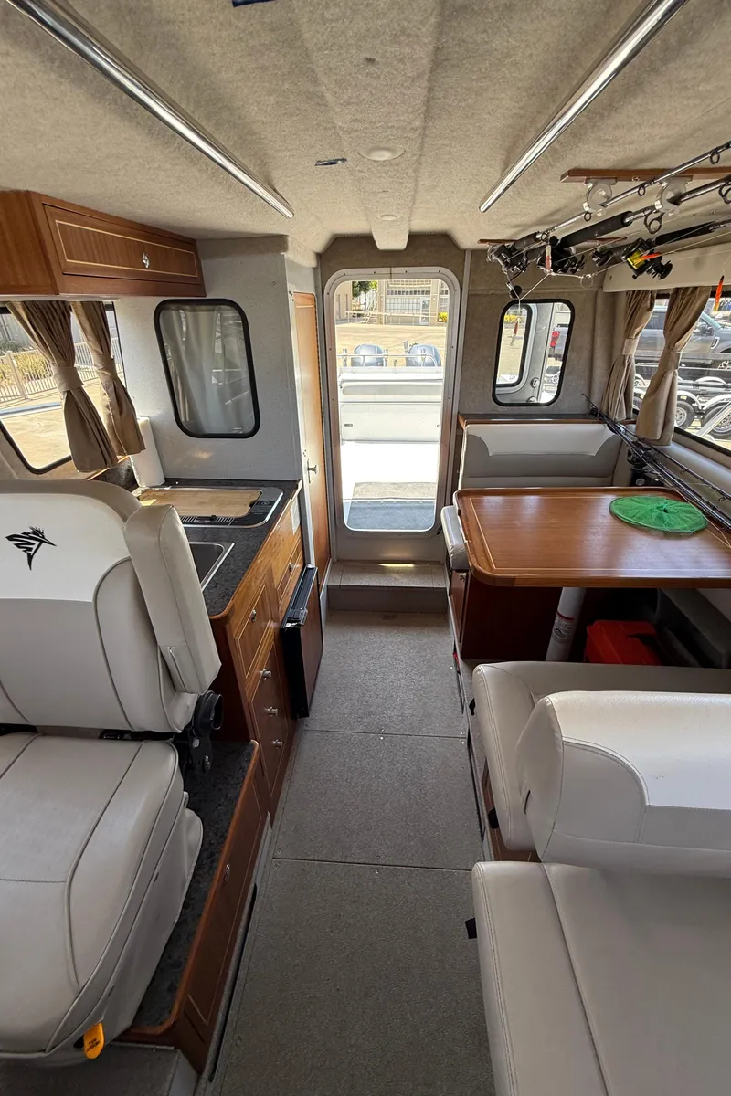 Slide: The Image of Interior of 2016 KingFisher 3025 Destination boat with seating, table, and kitchenette. - 17