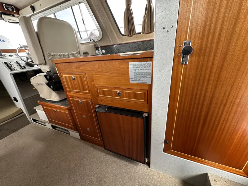Slide: The Image of Interior of 2016 KingFisher 3025 Destination boat with wood cabinetry and seating. - 20