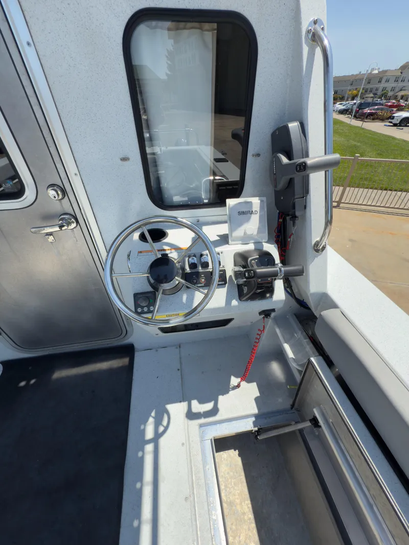 Slide: The Image of 2016 KingFisher 3025 Destination boat helm with steering wheel and controls. - 23