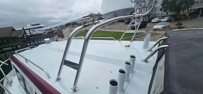 Slide: The Image of 2016 KingFisher 3025 Destination boat docked, showcasing rooftop and marina view. - 25