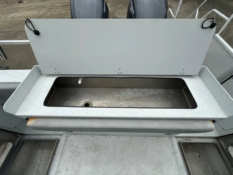 Slide: The Image of Open storage compartment on 2016 KingFisher 3025 Destination boat deck. - 28