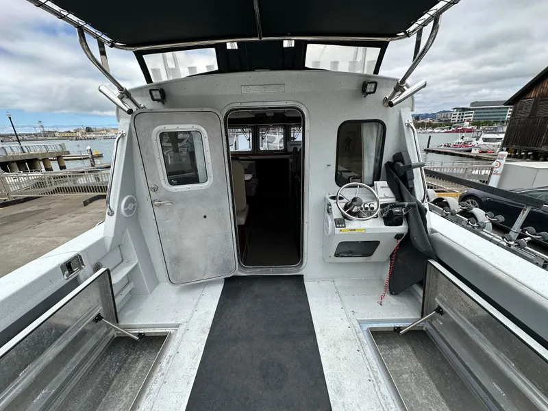 Slide: The Image of 2016 KingFisher 3025 Destination boat interior with steering wheel, docked at marina. - 29