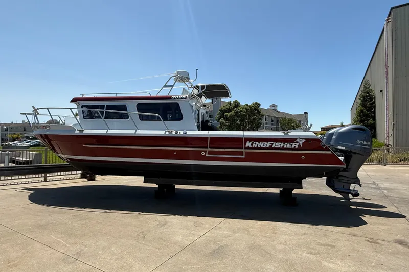 Slide: The Image of 2016 KingFisher 3025 Destination boat on display, featuring sleek red and white design. - 3