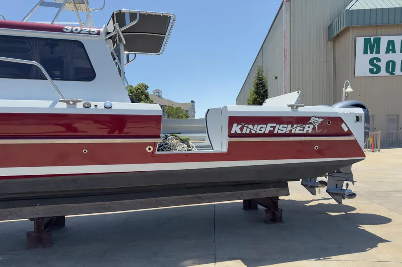Slide: The Image of 2016 KingFisher 3025 Destination boat on display, red and white exterior, docked outdoors. - 4