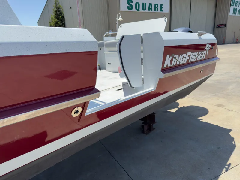 Slide: The Image of Red 2016 KingFisher 3025 Destination boat docked near industrial buildings. - 5