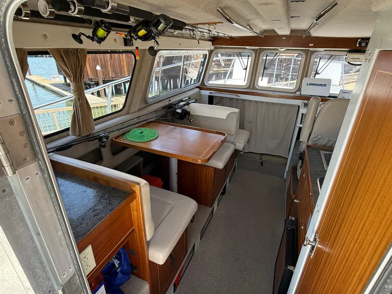 Slide: The Image of Interior of 2016 KingFisher 3025 Destination boat with seating and fishing rods. - 6