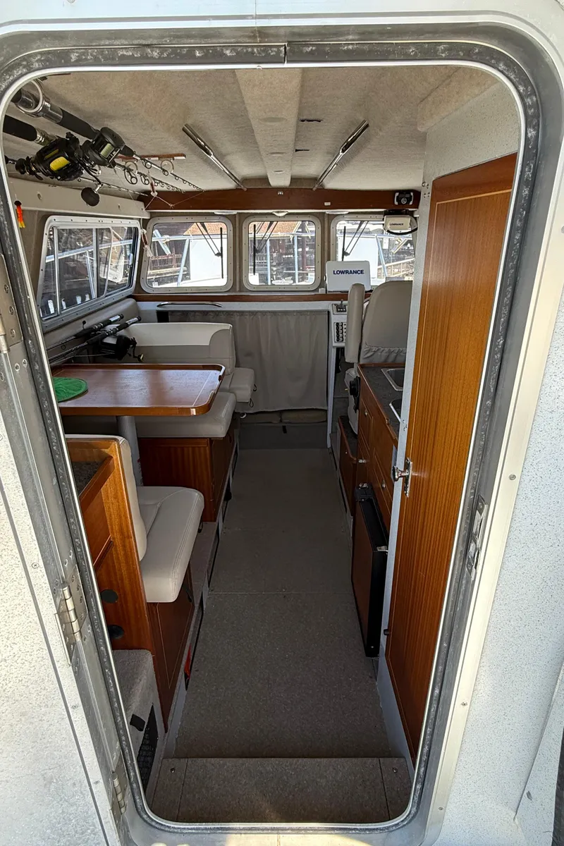 Slide: The Image of Interior of 2016 KingFisher 3025 Destination boat with seating and fishing gear. - 9