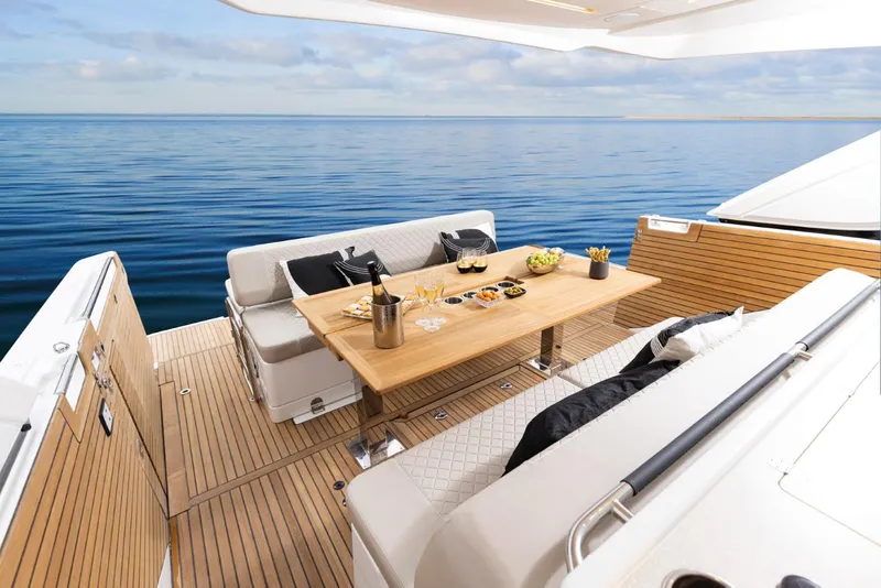 Slide: The Image of Luxurious Jeanneau DB 43 yacht deck with elegant dining setup, 2025 model. - 10