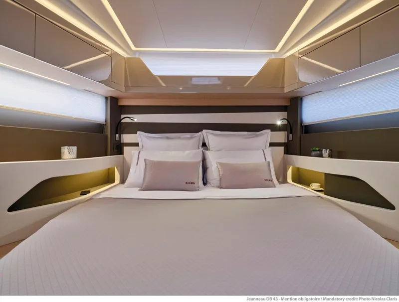 Slide: The Image of Luxurious interior of 2025 Jeanneau DB 43 yacht cabin with modern design and ambient lighting. - 13