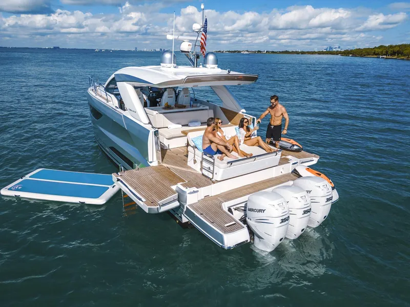 Slide: The Image of 2025 Jeanneau DB 43 yacht with people relaxing on deck, cruising in open water. - 8