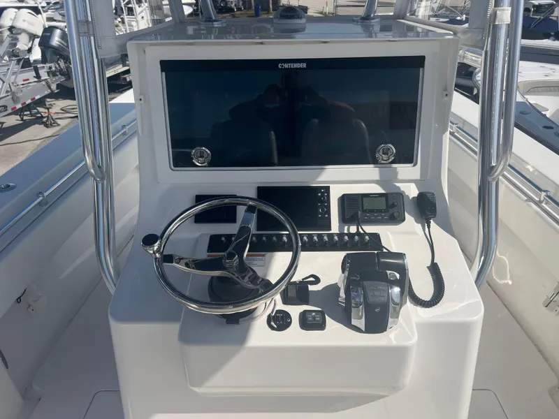 Slide: The Image of 2021 Contender 32 ST boat console with steering wheel and navigation controls. - 10