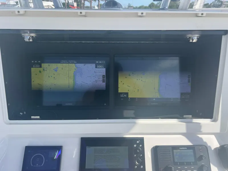 Slide: The Image of Dashboard of a 2021 Contender 32 ST boat with Garmin navigation displays. - 11