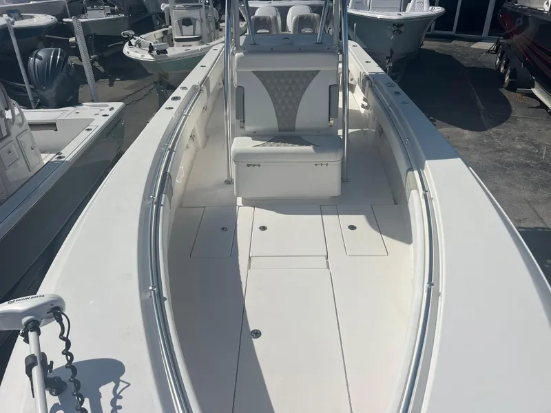 Slide: The Image of 2021 Contender 32 ST boat, white interior, docked among other boats. - 16