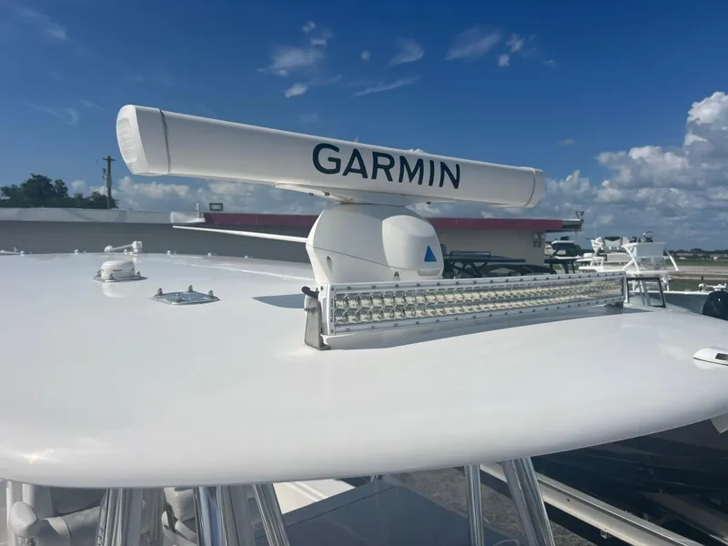 Slide: The Image of Garmin radar on 2021 Contender 32 ST boat under clear blue sky. - 17