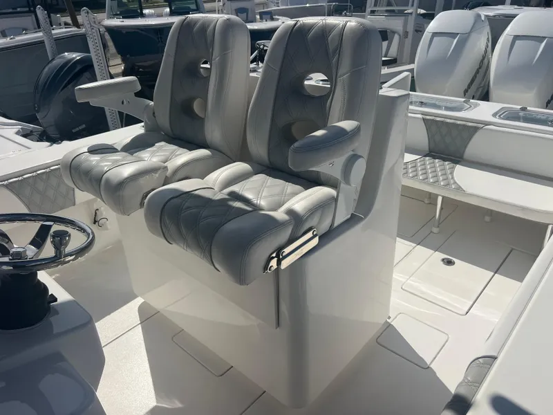 Slide: The Image of 2021 Contender 32 ST boat interior with dual cushioned seats and steering wheel. - 20