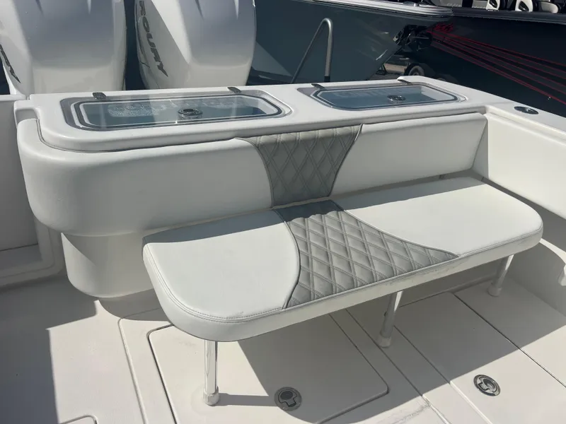 Slide: The Image of 2021 Contender 32 ST boat with cushioned seating and storage compartments. - 22