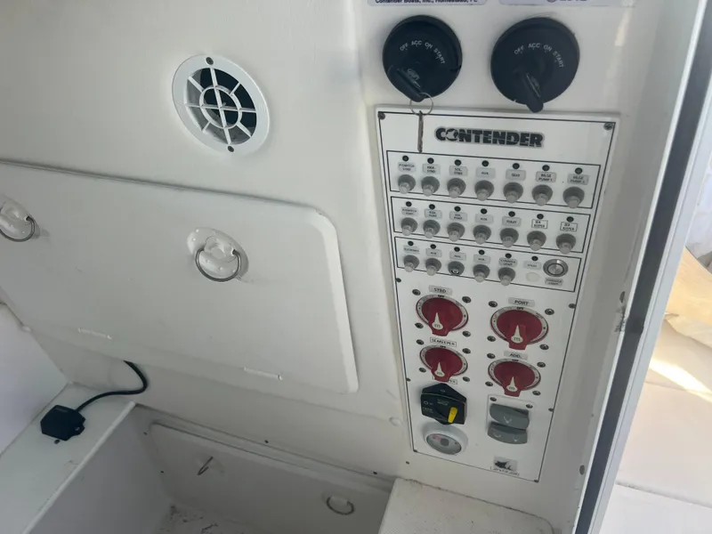 Slide: The Image of Control panel of a 2021 Contender 32 ST boat with switches and dials. - 24