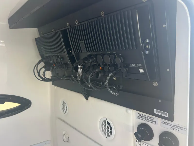 Slide: The Image of 2021 Contender 32 ST boat electronics panel with wiring and controls. - 25