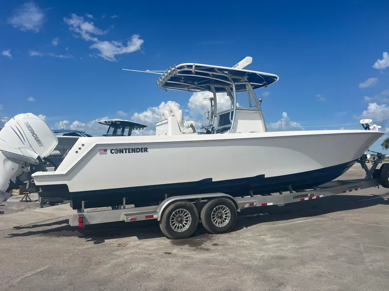 Slide: The Image of 2021 Contender 32 ST boat on trailer under clear blue sky. - 4