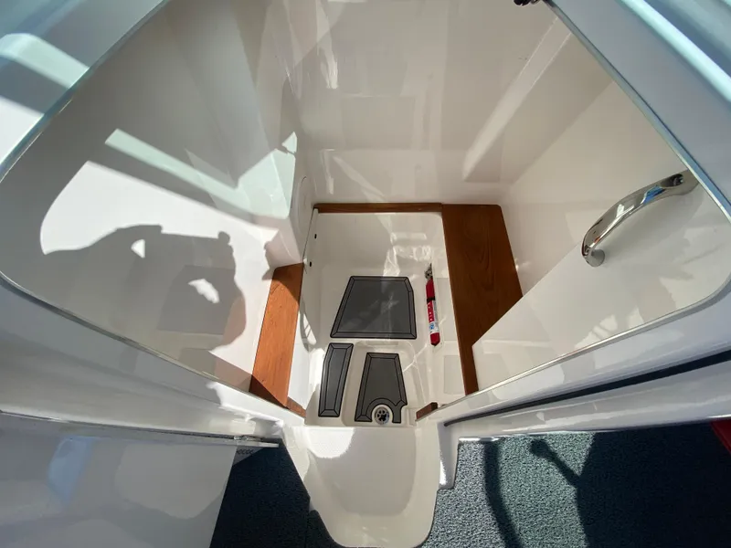 Slide: The Image of 2020 MasterCraft X26 boat interior with sleek white and wood finish. - 29