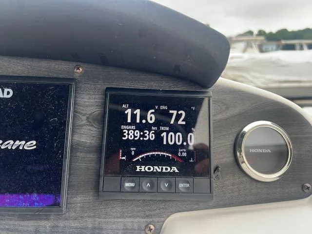 Slide: The Image of Dashboard of a 2021 Hurricane FunDeck 236SB OB boat with Honda engine display. - 12