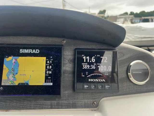 Slide: The Image of Dashboard of 2021 Hurricane FunDeck 236SB OB with Simrad and Honda displays. - 13