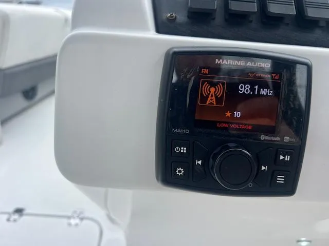 Slide: The Image of Marine audio system on 2021 Hurricane FunDeck 236SB OB, displaying FM 98.1 MHz. - 14