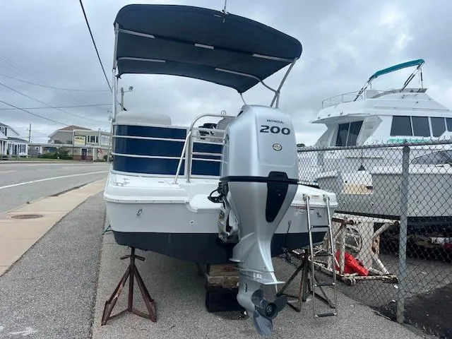 Slide: The Image of 2021 Hurricane FunDeck 236SB OB boat with Honda 200 outboard motor on a trailer. - 3