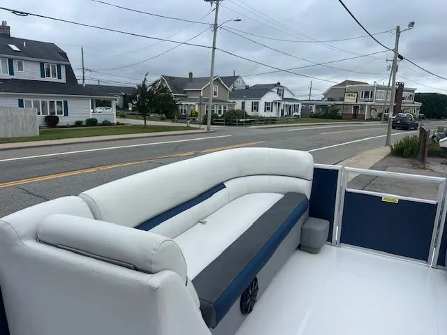 Slide: The Image of 2021 Hurricane FunDeck 236SB OB boat with white seating, parked near residential street. - 6