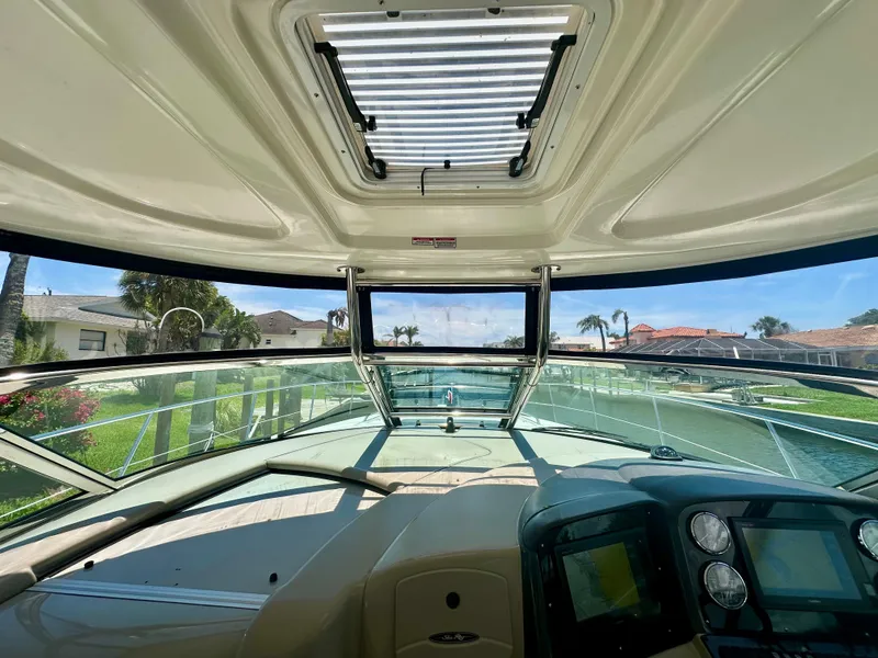 Slide: The Image of Interior view of 2005 Sea Ray 420 Sundancer yacht cockpit with clear windshield and control panel. - 13