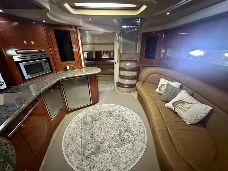 Slide: The Image of Luxurious interior of 2005 Sea Ray 420 Sundancer yacht with modern kitchen and cozy seating area. - 18