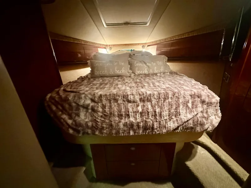 Slide: The Image of Cozy bedroom interior of 2005 Sea Ray 420 Sundancer yacht with plush bedding. - 19