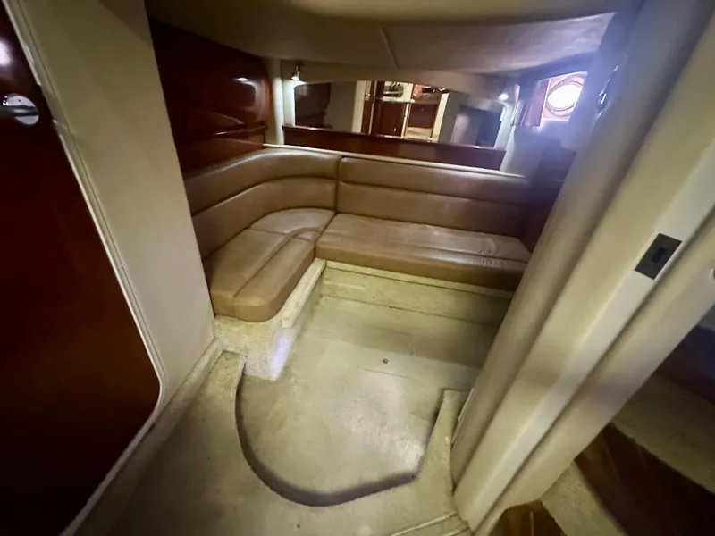 Slide: The Image of Interior of 2005 Sea Ray 420 Sundancer with beige leather seating and wooden accents. - 24