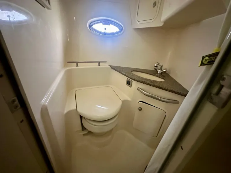 Slide: The Image of 2005 Sea Ray 420 Sundancer bathroom with compact toilet and sink. - 26