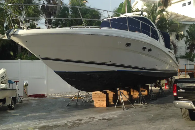 Slide: The Image of 2005 Sea Ray 420 Sundancer yacht on stands, surrounded by tropical foliage. - 3