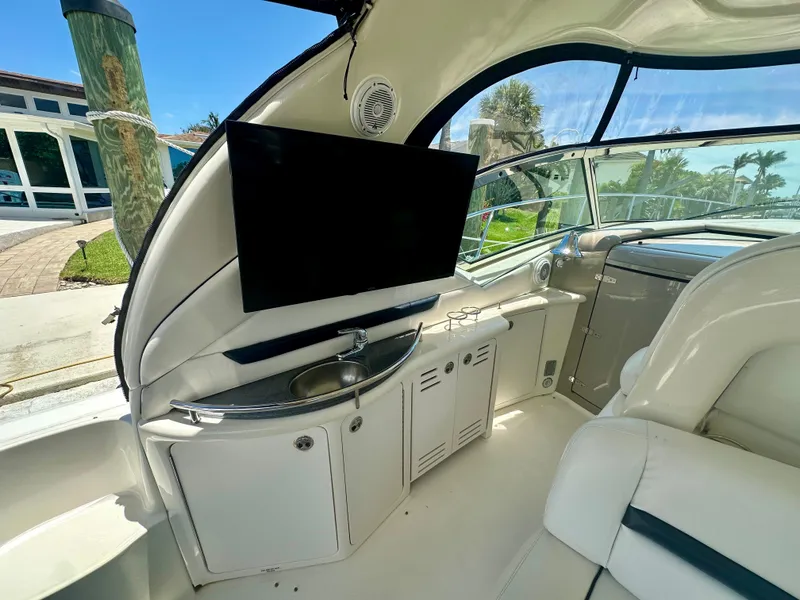 Slide: The Image of 2005 Sea Ray 420 Sundancer interior with TV, sink, and seating area. - 9