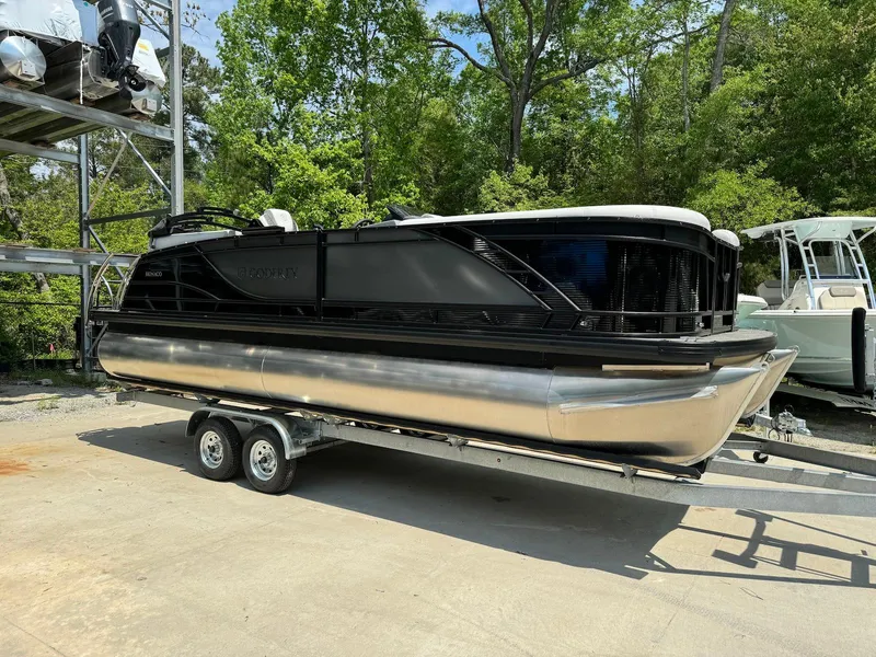 Slide: The Image of 2024 Godfrey Monaco 235 SB pontoon boat on trailer at dealership. - 1