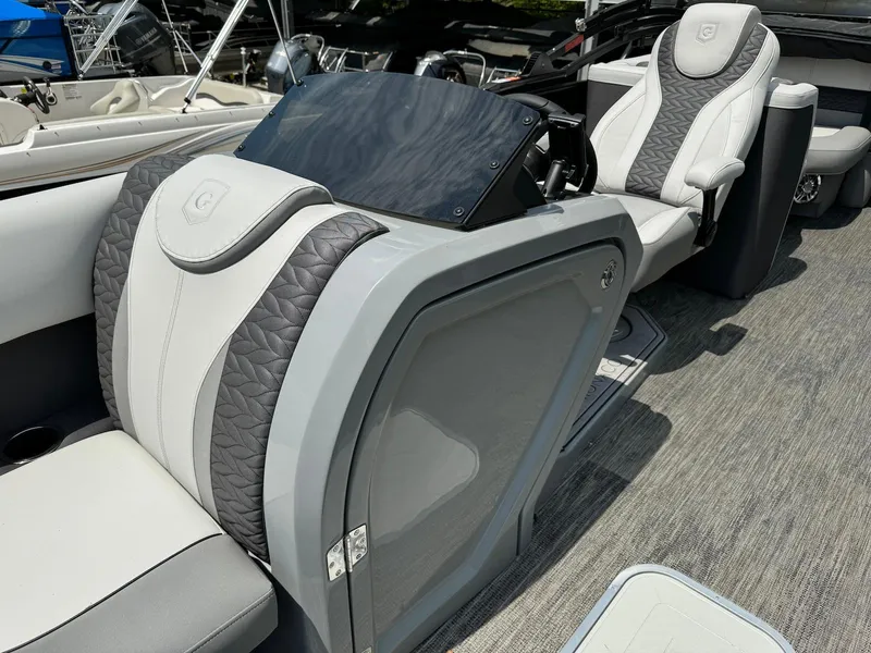 Slide: The Image of Control panel and cup holders on 2024 Godfrey Monaco 235 SB boat. - 17
