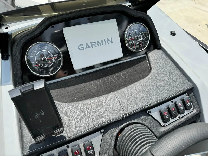 Slide: The Image of Control panel of 2024 Godfrey Monaco 235 SB boat with key and cup holders. - 19