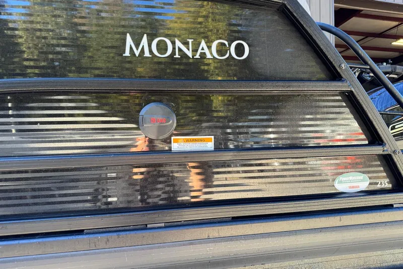 Slide: The Image of 2024 Godfrey Monaco 235 SB boat with sleek black exterior detailing. - 35