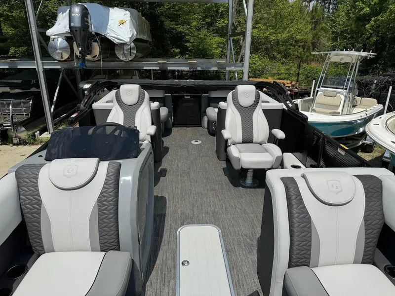 Slide: The Image of 2024 Godfrey Monaco 235 SB pontoon boat interior with luxurious seating and modern design. - 9