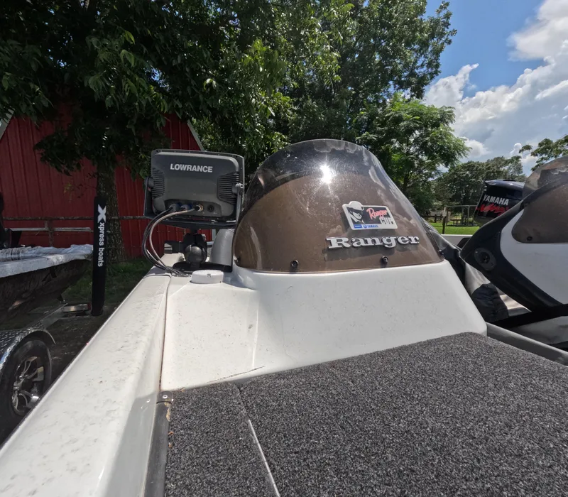Slide: The Image of 2006 Ranger 521DVX Comanche boat with Lowrance equipment, parked outdoors. - 5