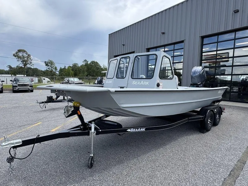 Slide: The Image of 2026 SeaArk 2072 MV Flat Cat boat on trailer, parked outside a building. - 0