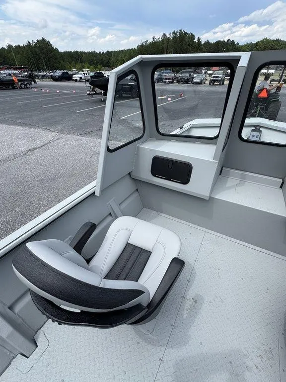 Slide: The Image of 2026 SeaArk 2072 MV Flat Cat boat interior with seating and windows. - 10