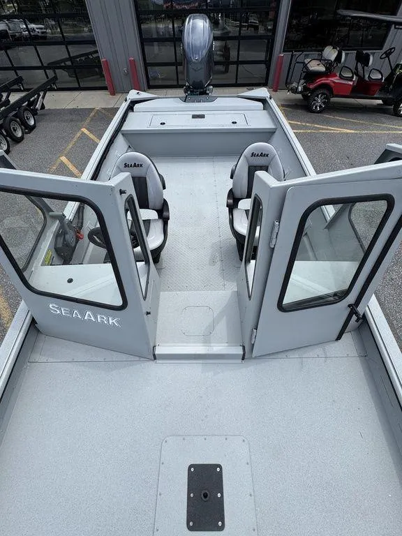 Slide: The Image of 2026 SeaArk 2072 MV Flat Cat boat interior with open doors and seating. - 12