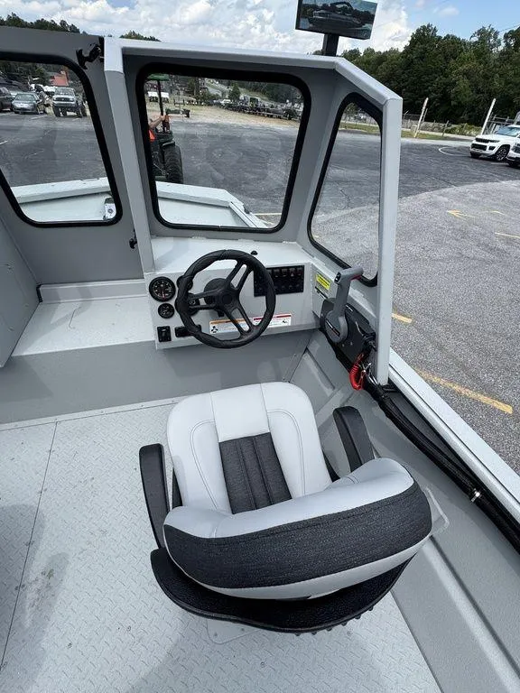 Slide: The Image of Interior of 2026 SeaArk 2072 MV Flat Cat boat with steering wheel and seat. - 13