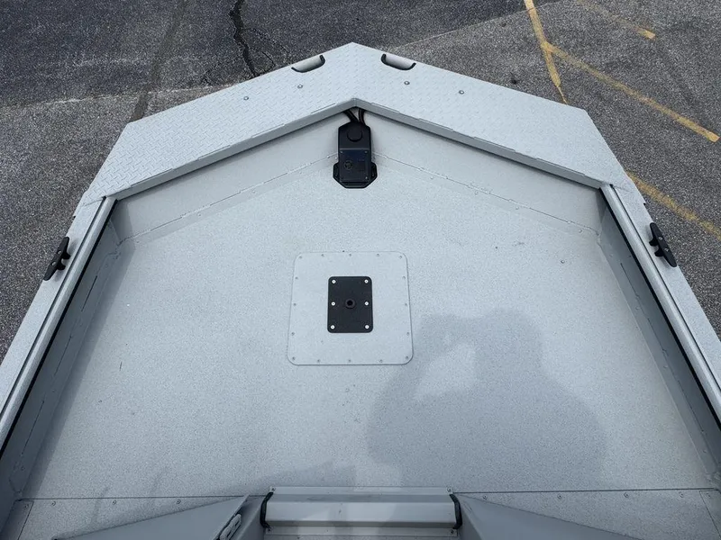 Slide: The Image of 2026 SeaArk 2072 MV Flat Cat boat deck, gray surface, outdoor setting. - 14