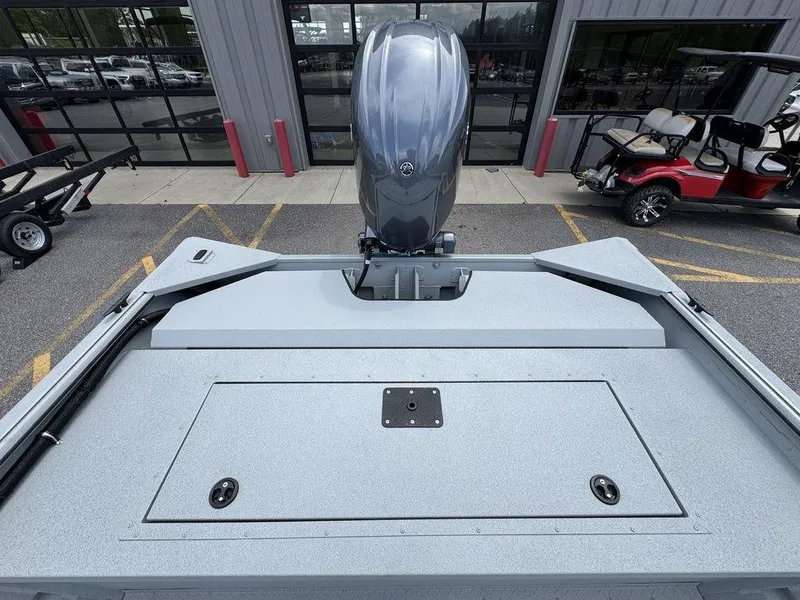 Slide: The Image of 2026 SeaArk 2072 MV Flat Cat boat with outboard motor, parked outside dealership. - 19