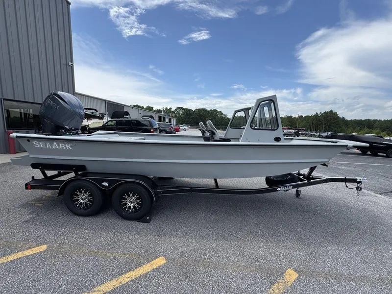Slide: The Image of 2026 SeaArk 2072 MV Flat Cat boat on trailer, parked outdoors under blue sky. - 2